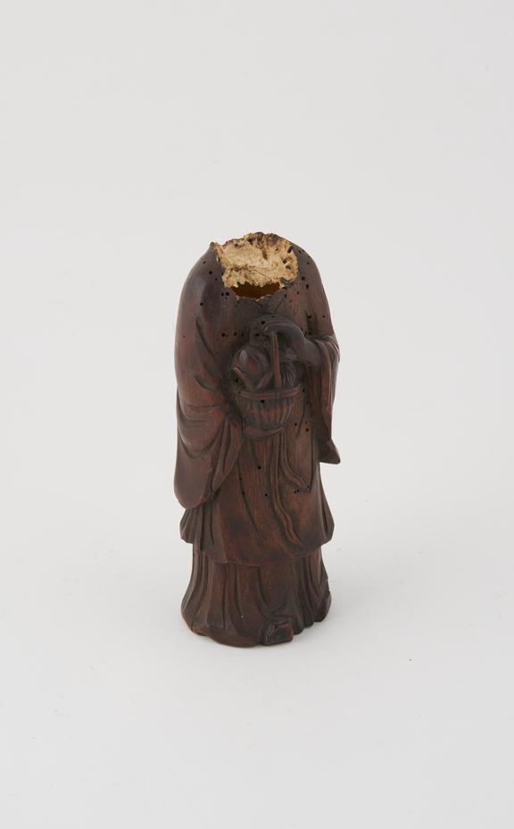 Figure, carved wood, cloaked figure, holding basket of fruit