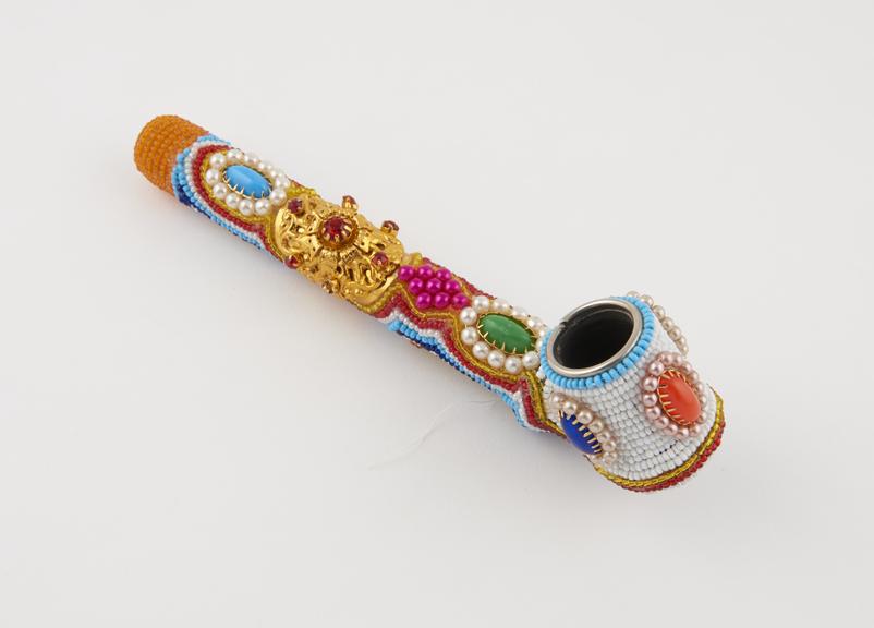 Tobacco pipe, clay, covered in bright stones and beads of glass