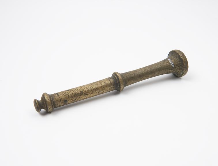 Bronze pestle, trumpet-like grinding end, disc and knob finial