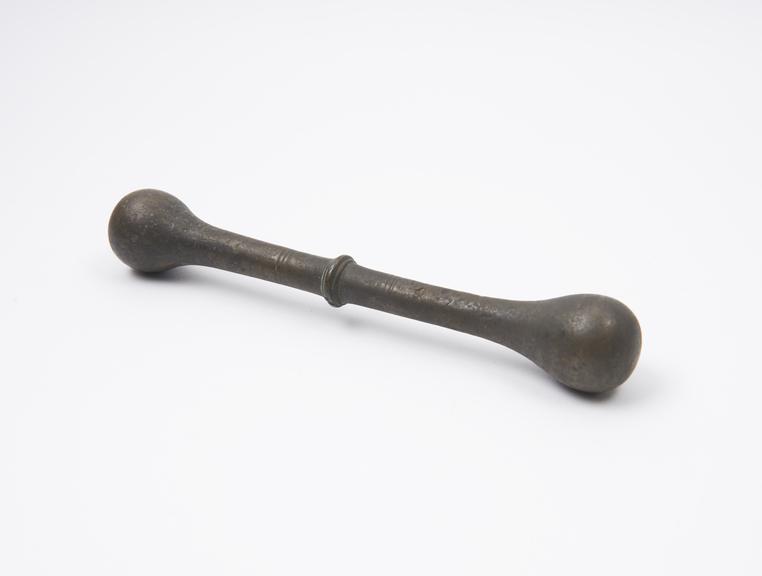 Bronze double-ended pestle with central flange, European