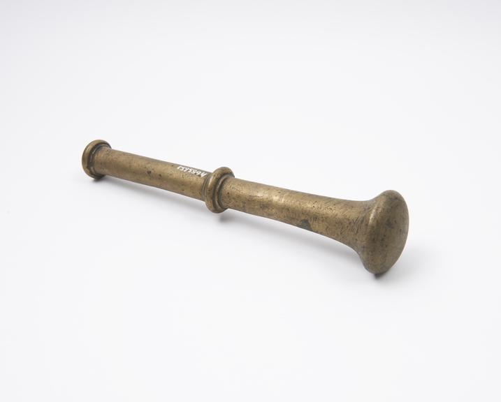 Brass pestle with flange and button finial, European