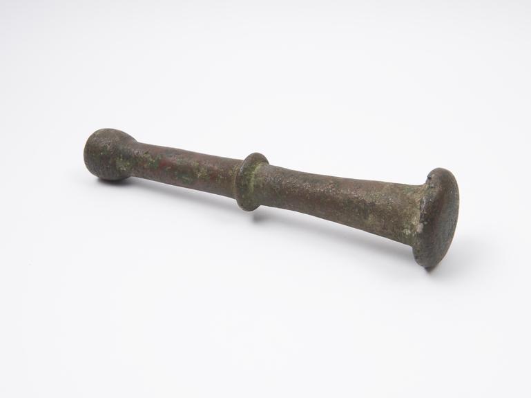 Bronze pestle with central flange and knob finial, European