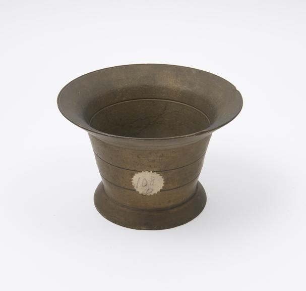 Small bell shaped mortar, wide flared rim and foot, flat base