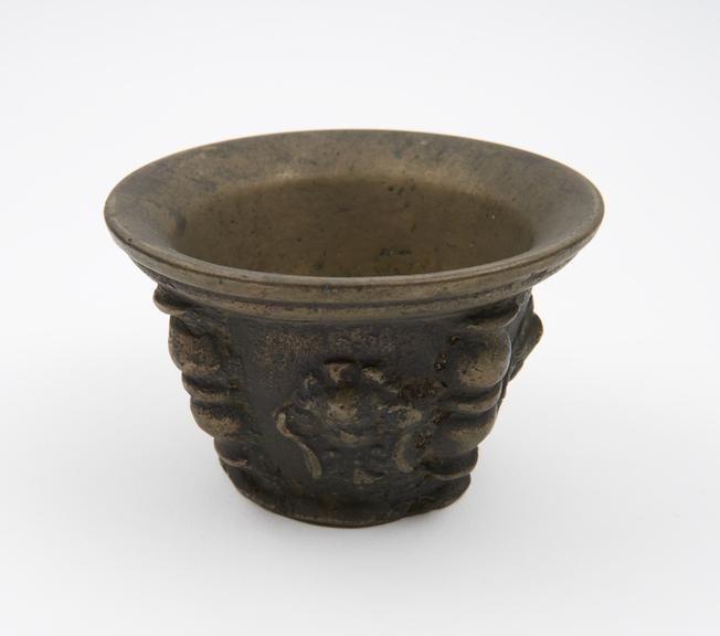 Small squat bronze mortar, flared rim and foot, flat base