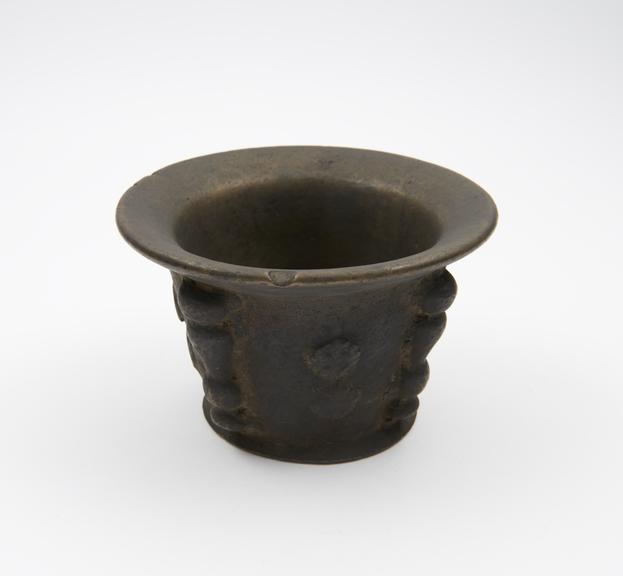 Small squat bronze mortar, flared rim and foot, flat base