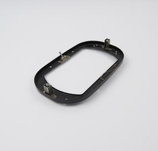 Black coloured metal mounting strip, for Lucas rectangular head lamp, 1967