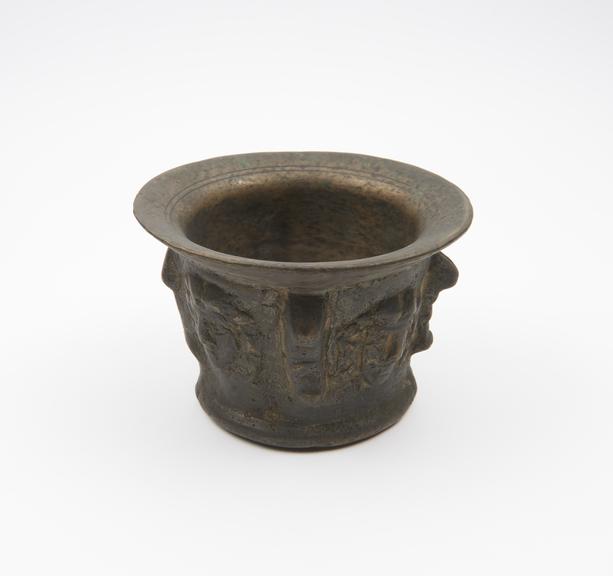 Small squat bronze mortar, flared rim and foot, flat base