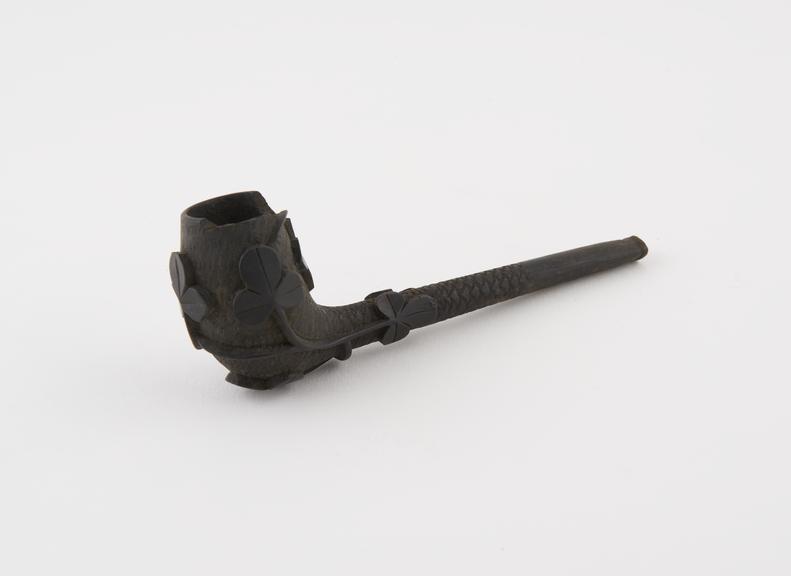 Black wooden tobacco pipe evocative of clay pipe