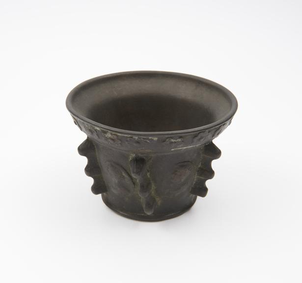 Small squat bronze mortar, everted rim decorated with roses