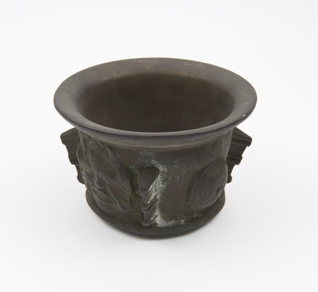 Small squat bronze mortar, everted rim, mauded foot, bowed base