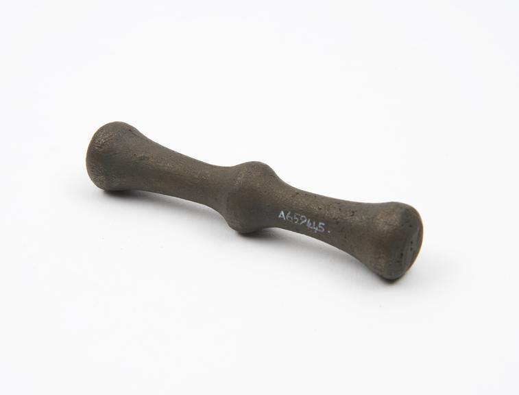 Double-ended bronze pestle with moulded bulbous ring at centre