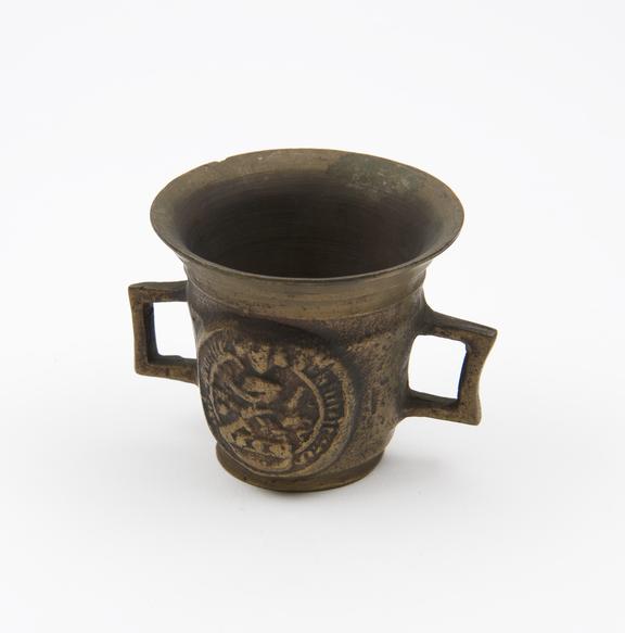 Small brass mortar decorated with coat of arms