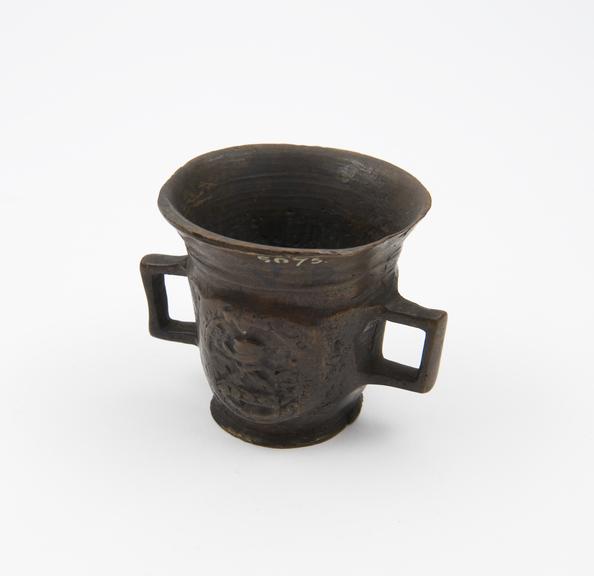 Small brass mortar decorated with coat of arms