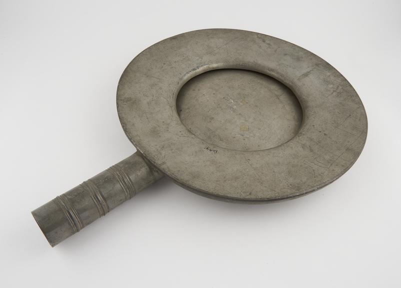 Circular pewter bedpan, crushed