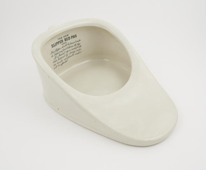 Slipper' cream-glazed earthenware bedpan, with handle