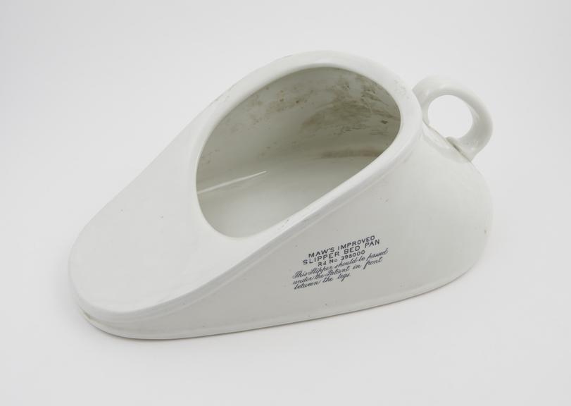 White earthenware slipper type bedpan, by S