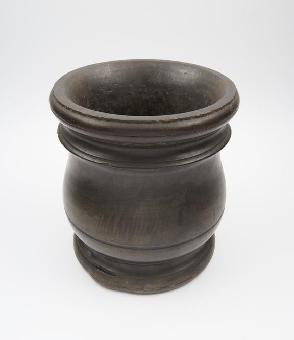 Turned wooden mortar with flat base and bulbous body