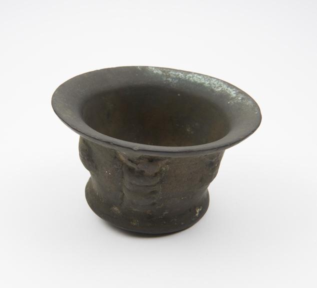 Small squat bronze mortar, wide flared rim and foot, flat base