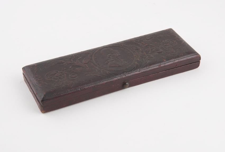 Leather covered wooden box, embossed with medallion