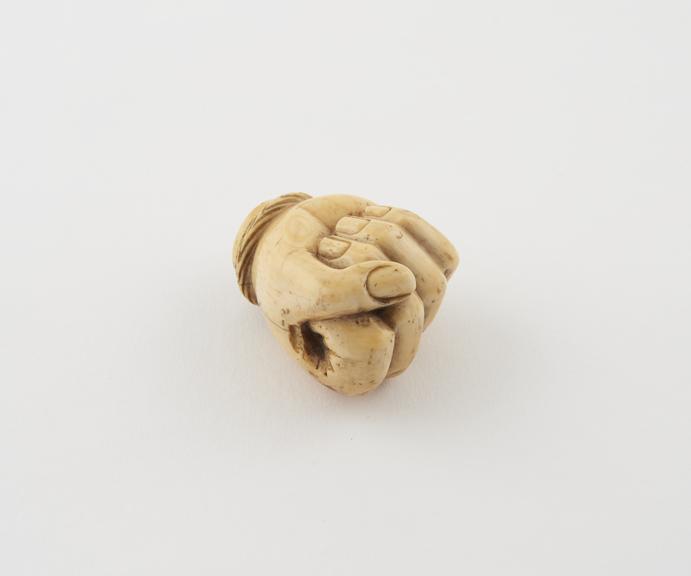 Ivory knob from a cane, in the shape of a hand