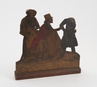 Samuel being accosted by an election agent, Rachel to left.  From a series of  cardboard scenes, a saga involving a man called Samuel and his sweetheart, a girl called Rachel