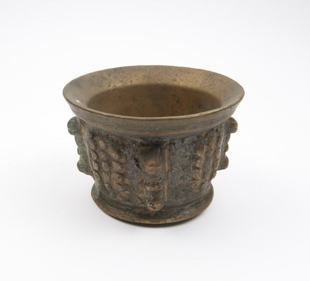 Small and squat brass (?) mortar, flared rim and foot