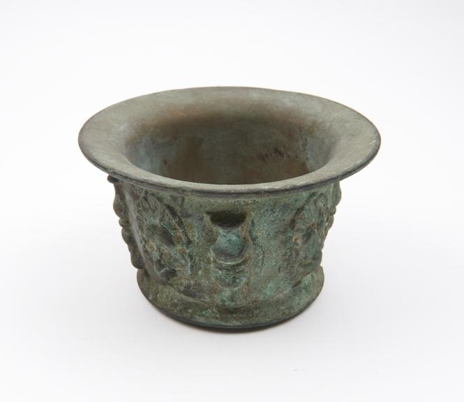 Small squat bronze mortar, flared rim and foot, flat base