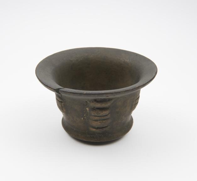 Small squat bronze mortar, flared rim and foot, flat base