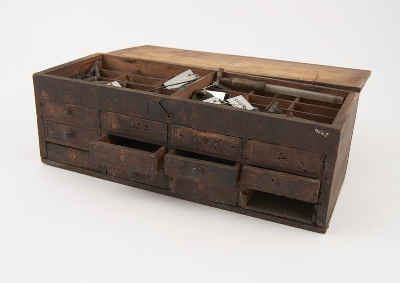 Instrument case with small drawers containing numerous small