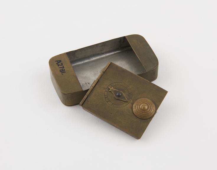 Brass oblong snuff box, hinge and lock broken, clockface on lid