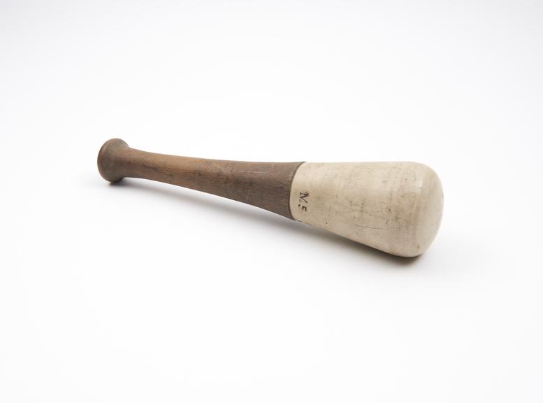 Pestle with ceramic grinding end and burned wooden handle