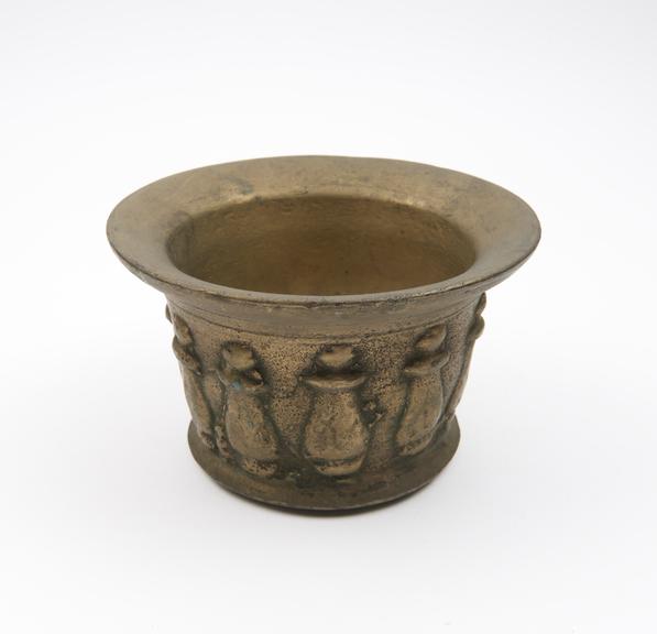 Squat bronze mortar, wide flared rim, protruding foot