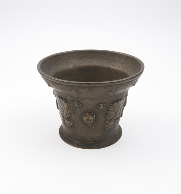 Bronze mortar, deep flared rim, flat base and protruding foot