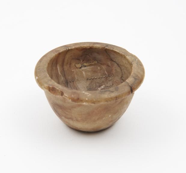 Small bowl-shaped mortar, of polished yellowy-brown quartz