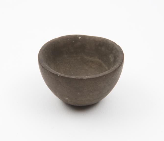 Tiny bowl-like mortar, carved from fairly smooth stone