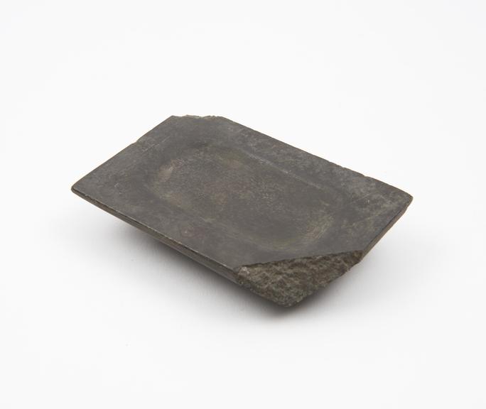 Rectangular stone palette with oval depression in top