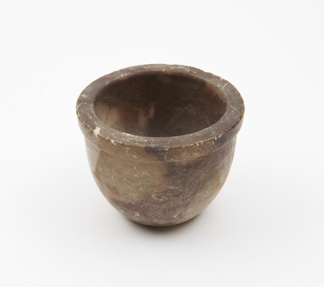 Stone mortar cup-shaped with flat base, rounded body, flat rim