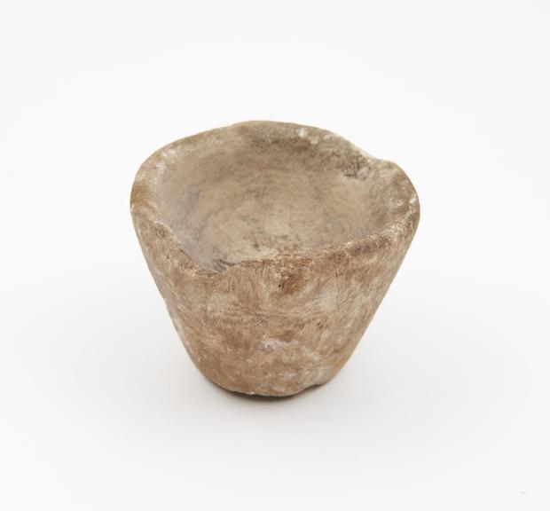 Stone mortar with flat base flaring sides, 2 lugs