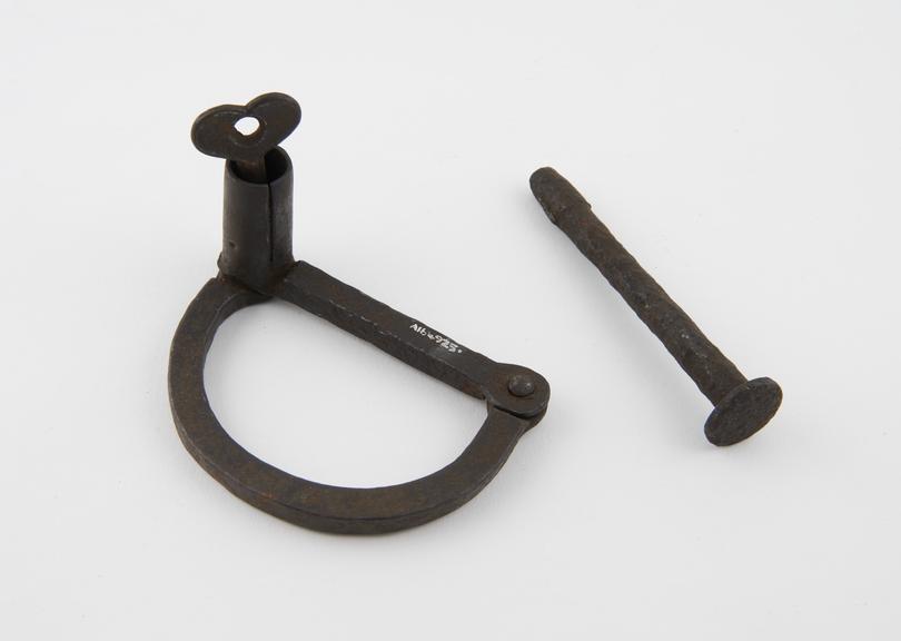 Manacle, iron, with key but without padlock, possibly English