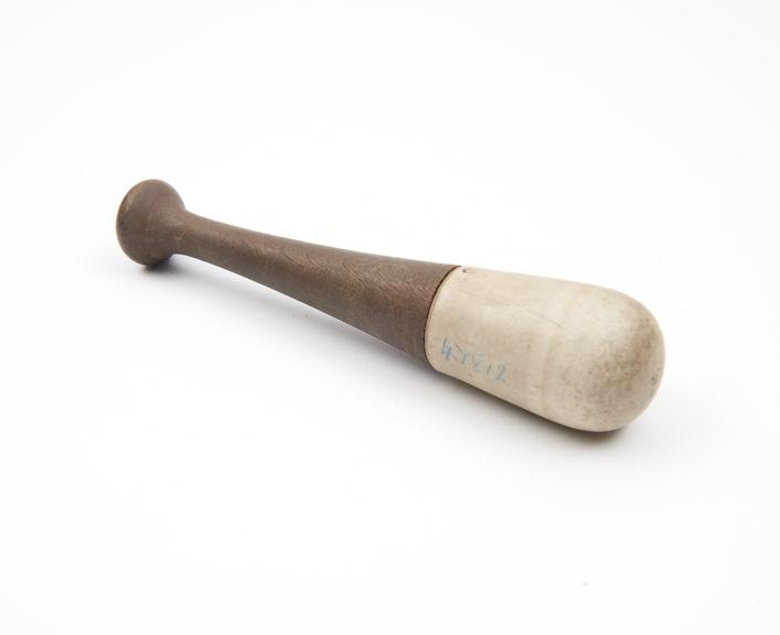 Pestle with ceramic grinding end and turned wooden handle