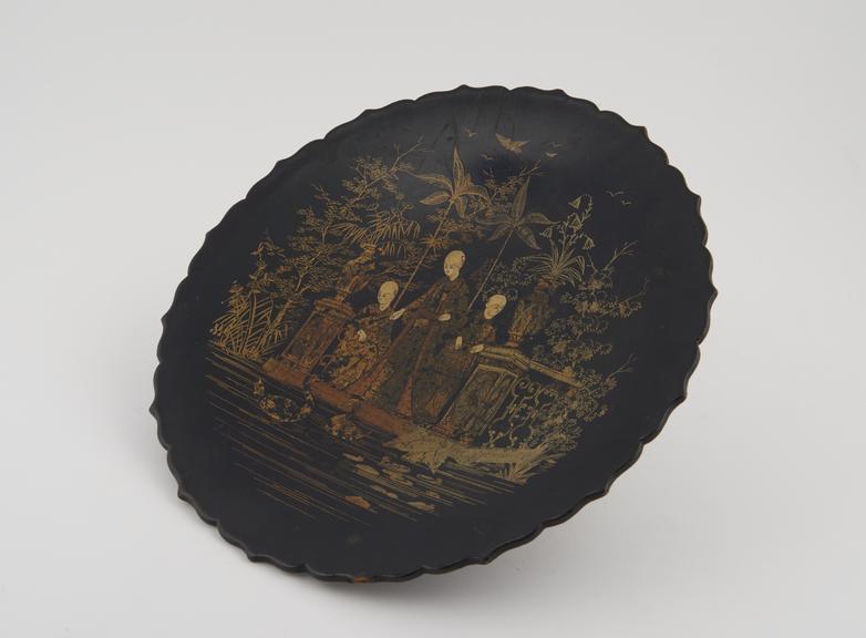 Laquered plate, decorated with garden scene, Far Eastern