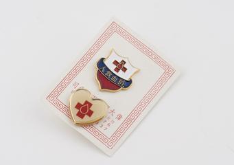 Two blood donor badges on a white card
