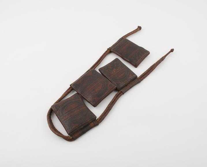 Leather thong belt with four leather amuletic cases attached