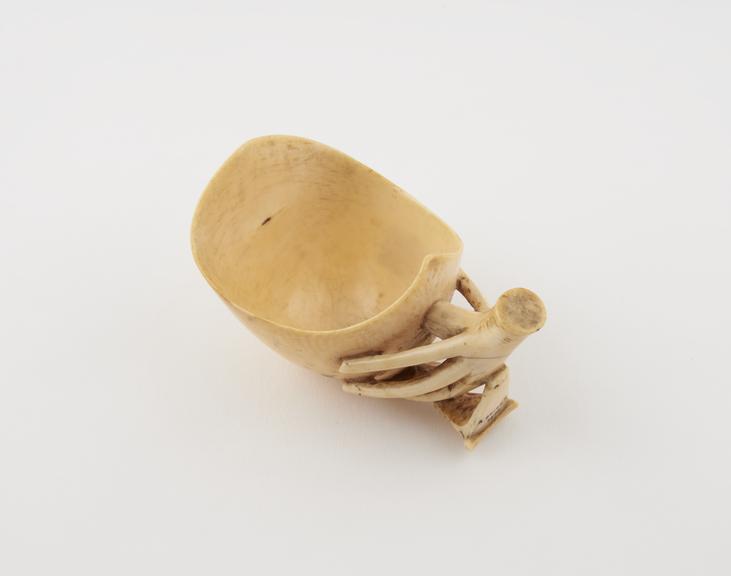 Ivory vessel, possibly a medicine cup, with elaborate handle