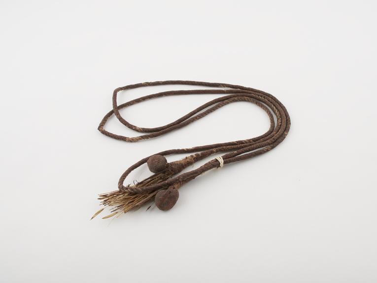 Amuletic bundles, attached to either end of a dyed fibre cord