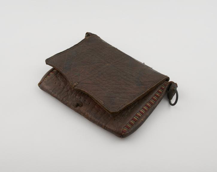 Leather pouch containing ancient manuscript. With sling