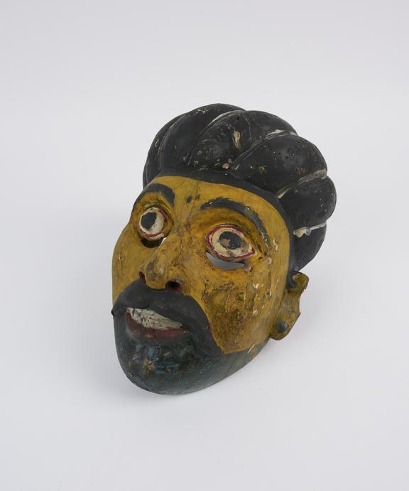 Painted wooden face mask, yellow with polychrome detail