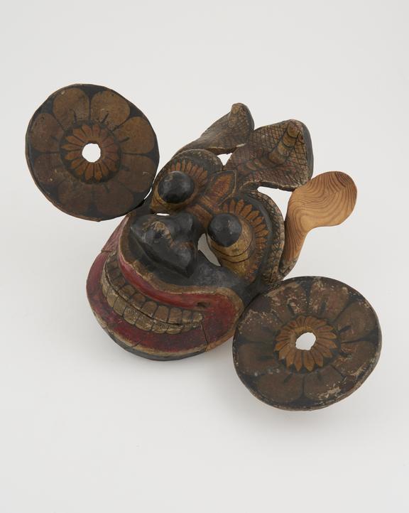 Painted wooden mask polychrome, with lotus-disc ear pieces