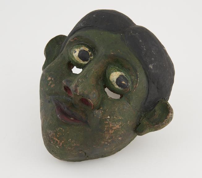 Painted wooden face mask, green with polychrome detail