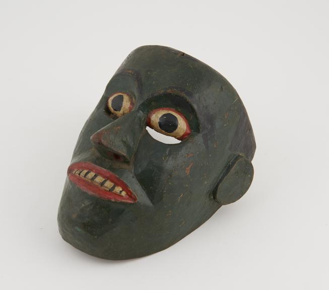 Painted wooden face-mask, green with polychrome detail